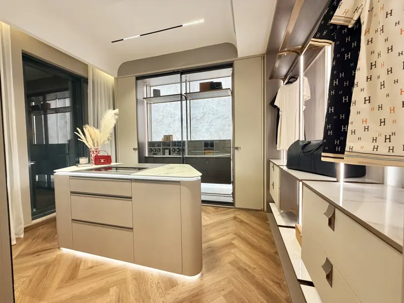 Modenzo walk-in closet with marble-top island and lit cabinetry, real photo
