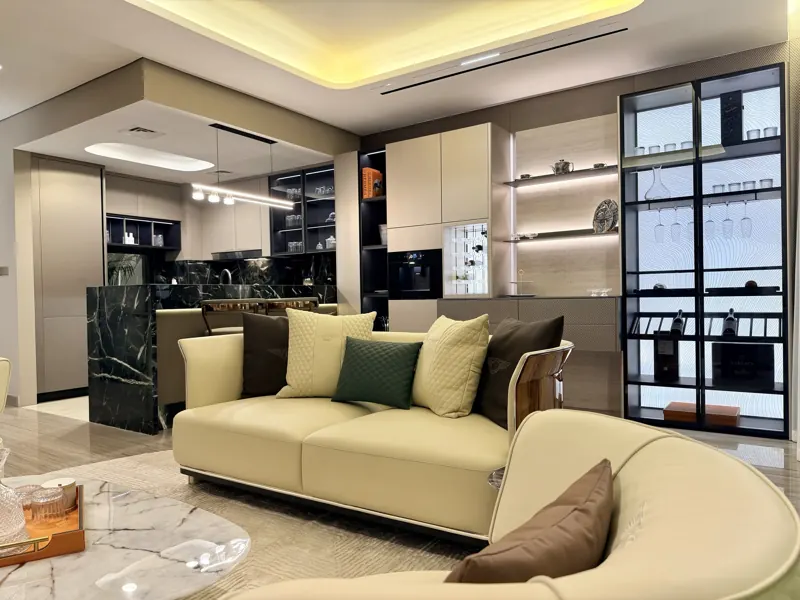 Open-plan kitchen and living room with black marble island by Modenzo, real photo