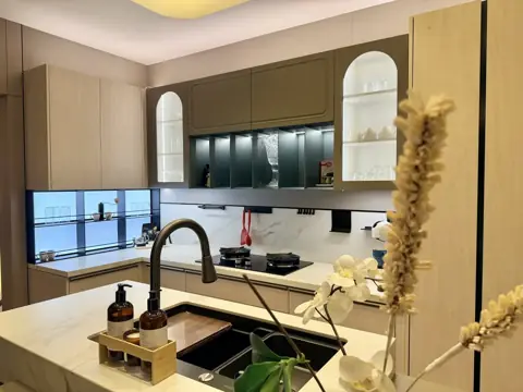 Marble island with black sink and brass tap